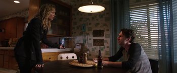 Movie still from “Wish I Was Here” (2014), directed by Zach Braff – Two people sitting at a table with a bottle of beer in front of them; Medium shot, Over the shoulder angle
