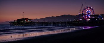 Movie still from “Wish I Was Here” (2014), directed by Zach Braff – A view of the ocean at night with lights on; Extreme Wide shot, Low angle