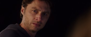 Movie still from “Wish I Was Here” (2014), directed by Zach Braff – A man's face in the dark; Close Up shot, Over the shoulder angle