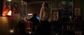 Movie still from “Wish I Was Here” (2014), directed by Zach Braff – A woman standing in front of a computer screen; Wide shot, Over the shoulder angle