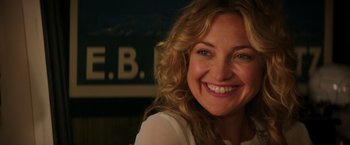 Movie still from “Wish I Was Here” (2014), directed by Zach Braff – A person smiling for the camera; Close Up shot, Over the shoulder angle