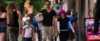Movie still from “Wish I Was Here” (2014), directed by Zach Braff – A man and a woman walking down a street; Medium shot, Low angle