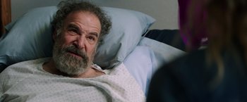 Movie still from “Wish I Was Here” (2014), directed by Zach Braff – An older man laying in a hospital bed; Close Up shot, Over the shoulder angle
