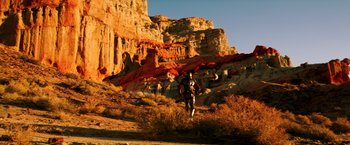 Movie still from “Wish I Was Here” (2014), directed by Zach Braff – A person is walking up a hill in the desert; Extreme Wide shot, High angle
