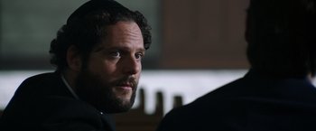 Movie still from “Wish I Was Here” (2014), directed by Zach Braff – A person wearing a suit and tie; Close Up shot, Over the shoulder angle