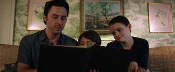 Movie still from “Wish I Was Here” (2014), directed by Zach Braff – A man and two children looking at a book; Close Up shot, Low angle