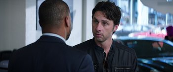 Movie still from “Wish I Was Here” (2014), directed by Zach Braff – A man in black jacket talking to another man in a suit; Close Up shot, Over the shoulder angle