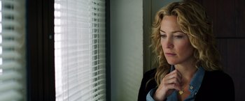 Movie still from “Wish I Was Here” (2014), directed by Zach Braff – A woman looking out of a window at a room; Close Up shot, Over the shoulder angle
