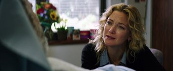 Movie still from “Wish I Was Here” (2014), directed by Zach Braff – A person sitting at a table; Close Up shot, Over the shoulder angle