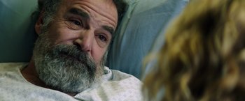 Movie still from “Wish I Was Here” (2014), directed by Zach Braff – An older man with a beard and a white shirt; Close Up shot, Over the shoulder angle