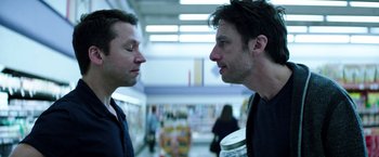 Movie still from “Wish I Was Here” (2014), directed by Zach Braff – Two men standing next to each other in a store; Close Up shot, Over the shoulder angle