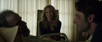 Movie still from “Wish I Was Here” (2014), directed by Zach Braff – A woman sitting in a chair in front of a window; Medium shot, Over the shoulder angle