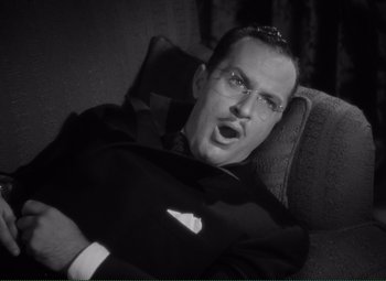 Movie still from “Without Love” (1945), directed by Harold S. Bucquet – A black and white photo of a man with glasses; Close Up shot, High angle