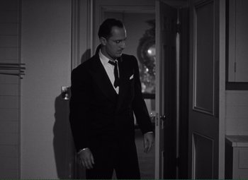 Movie still from “Without Love” (1945), directed by Harold S. Bucquet – A black and white photo of a man in a suit and tie; Medium shot, Low angle