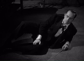 Movie still from “Without Love” (1945), directed by Harold S. Bucquet – A black and white photo of a man in a suit and tie; Medium shot, High angle