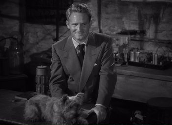Movie still from “Without Love” (1945), directed by Harold S. Bucquet – A black and white photo of a man and a dog; Medium shot, High angle
