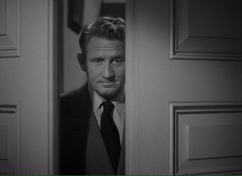 Movie still from “Without Love” (1945), directed by Harold S. Bucquet – A black and white photo of a man in a suit and tie; Medium shot, Over the shoulder angle