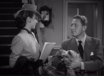 Movie still from “Without Love” (1945), directed by Harold S. Bucquet – A man and a woman are holding a dog; Medium shot, Over the shoulder angle
