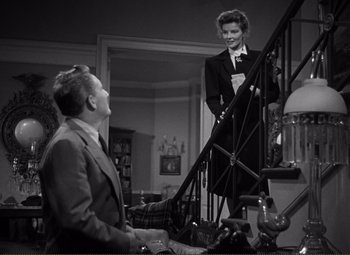 Movie still from “Without Love” (1945), directed by Harold S. Bucquet – A man and a woman standing at the bottom of a stair case; Medium shot, Low angle