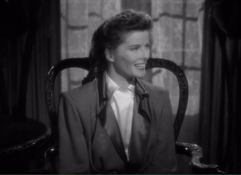 Movie still from “Without Love” (1945), directed by Harold S. Bucquet – A black and white photo of a woman sitting in a chair; Medium shot, High angle