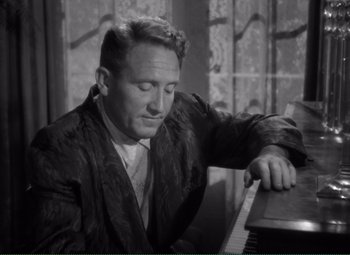 Movie still from “Without Love” (1945), directed by Harold S. Bucquet – A man sitting at a piano looking down at the keyboard; Close Up shot, High angle