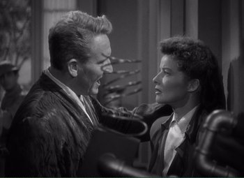 Movie still from “Without Love” (1945), directed by Harold S. Bucquet – A man and a woman face each other in a black and white photo; Medium shot, Over the shoulder angle