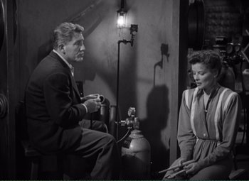 Movie still from “Without Love” (1945), directed by Harold S. Bucquet – A man and a woman sitting in a room; Medium shot, High angle