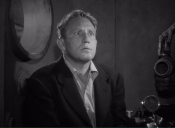 Movie still from “Without Love” (1945), directed by Harold S. Bucquet – An old photo of a man in a suit looking up; Close Up shot, High angle