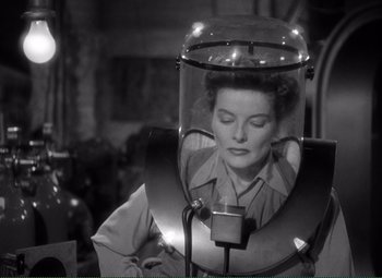 Movie still from “Without Love” (1945), directed by Harold S. Bucquet – A black and white photo of a woman in a hair dryer; Medium shot, High angle