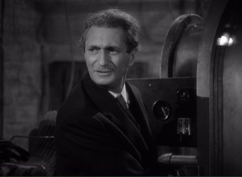 Movie still from “Without Love” (1945), directed by Harold S. Bucquet – An older man wearing a suit and tie in front of a camera; Close Up shot, High angle