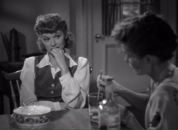 Movie still from “Without Love” (1945), directed by Harold S. Bucquet – A woman sitting at a table with another woman; Medium shot, Over the shoulder angle