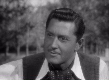 Movie still from “Without Love” (1945), directed by Harold S. Bucquet – An old photo of a man in a suit and tie; Close Up shot, High angle