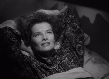 Movie still from “Without Love” (1945), directed by Harold S. Bucquet – A woman laying in a bed with her hands behind her head; Close Up shot, High angle