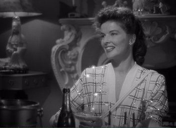 Movie still from “Without Love” (1945), directed by Harold S. Bucquet – A woman sitting at a table with a glass of wine in front of her; Close Up shot, Over the shoulder angle