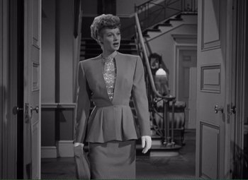 Movie still from “Without Love” (1945), directed by Harold S. Bucquet – A black and white photo of a woman in a suit; Medium shot, Low angle