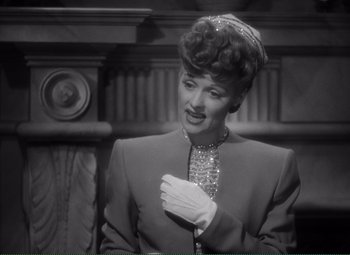 Movie still from “Without Love” (1945), directed by Harold S. Bucquet – A black - and - white photo of a woman in a suit; Close Up shot, High angle