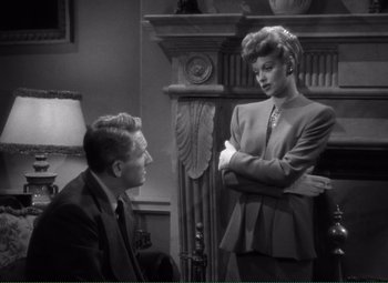 Movie still from “Without Love” (1945), directed by Harold S. Bucquet – A man and a woman standing next to each other in front of a fire place; Medium shot, Over the shoulder angle