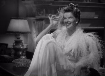 Movie still from “Without Love” (1945), directed by Harold S. Bucquet – An old black and white photo of a woman sitting on a chair; Medium shot, High angle