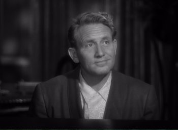 Movie still from “Without Love” (1945), directed by Harold S. Bucquet – An old photo of a man in a suit looking to his left; Close Up shot, High angle