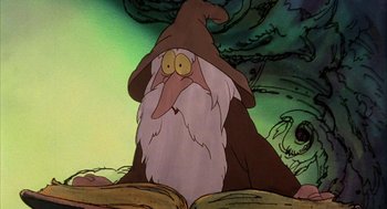 Movie still from “Wizards” (1977), directed by Ralph Bakshi – An old man with a long white beard is sitting on a book in front of a tree; Close Up shot, Low angle