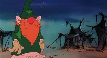 Movie still from “Wizards” (1977), directed by Ralph Bakshi – A gnome sitting in front of an old house; Medium shot, Low angle