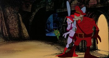 Movie still from “Wizards” (1977), directed by Ralph Bakshi – A woman in a red outfit and a man in a red outfit stand in front of a wall; Wide shot, Low angle