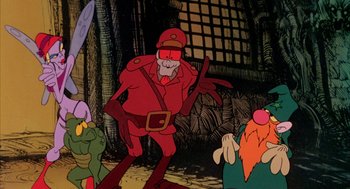 Movie still from “Wizards” (1977), directed by Ralph Bakshi – An animated character is standing in front of a group of other characters; Wide shot, Low angle