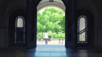Movie still from “Wolf Children” (2012), directed by Mamoru Hosoda – An image of people walking through an archway in a park; Extreme Wide shot, High angle