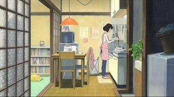 Movie still from “Wolf Children” (2012), directed by Mamoru Hosoda – A woman standing in a kitchen preparing a meal; Extreme Wide shot, High angle