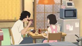 Movie still from “Wolf Children” (2012), directed by Mamoru Hosoda – Two people sitting at a dining table eating food; Wide shot, High angle