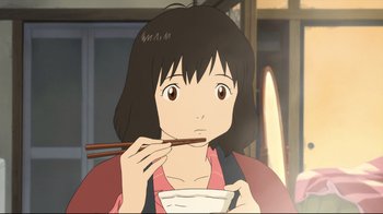 Movie still from “Wolf Children” (2012), directed by Mamoru Hosoda – A woman holding chopsticks while eating a bowl of food; Close Up shot, Low angle