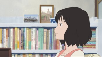 Movie still from “Wolf Children” (2012), directed by Mamoru Hosoda – A woman is looking at a book in front of a bookcase; Close Up shot, Over the shoulder angle