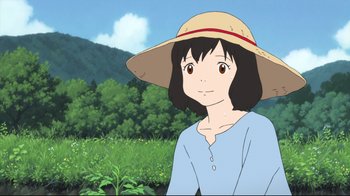 Movie still from “Wolf Children” (2012), directed by Mamoru Hosoda – A girl with a straw hat is standing in a field; Close Up shot, Over the shoulder angle