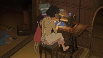 Movie still from “Wolf Children” (2012), directed by Mamoru Hosoda – A woman and a child sitting in front of a sewing machine; Wide shot, High angle